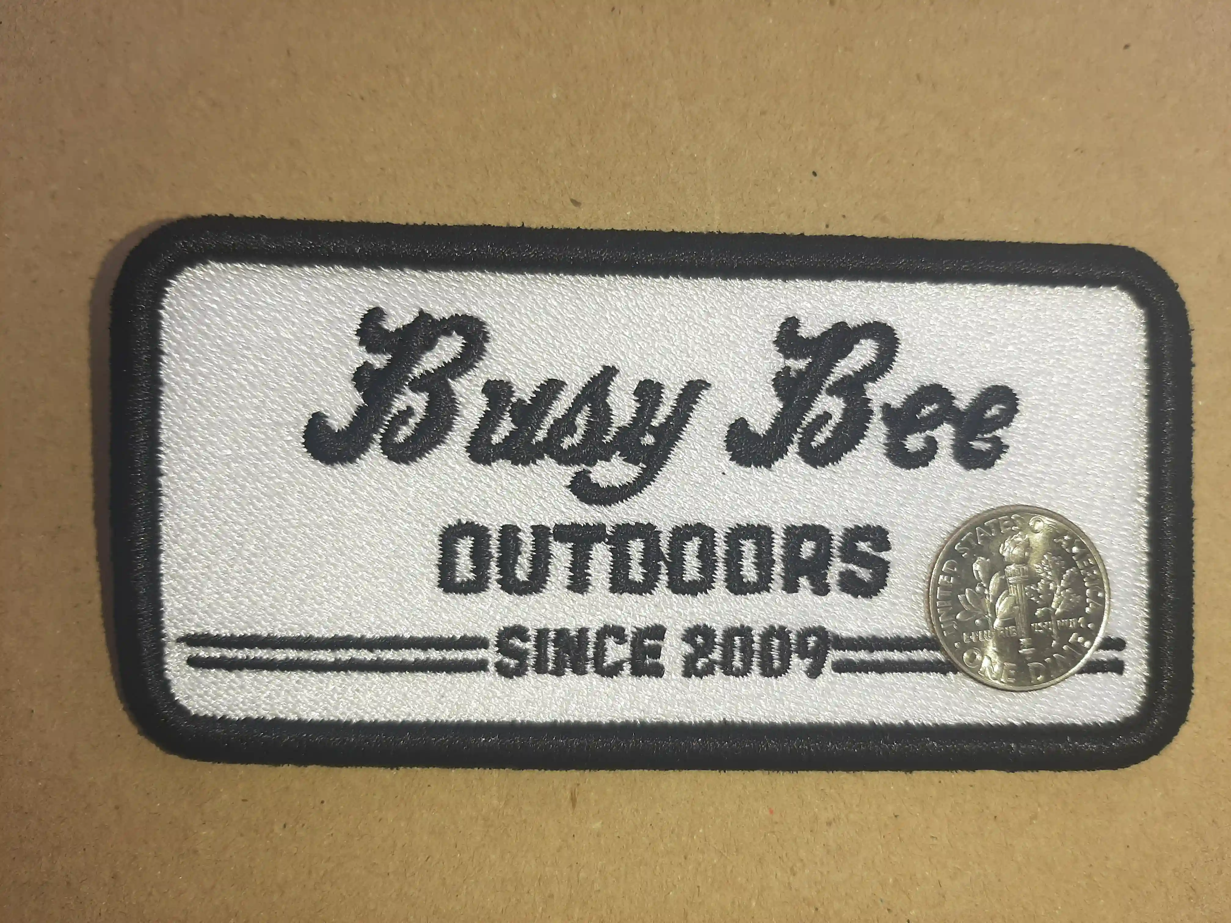Fancy Fonts for Busy Bee requires a Fancier Embroidery quality.  Abcoln creates pristine Fonts and shapes because it is hand digitized and no automated fonts Busy Bee Outdoors Apparel Branding